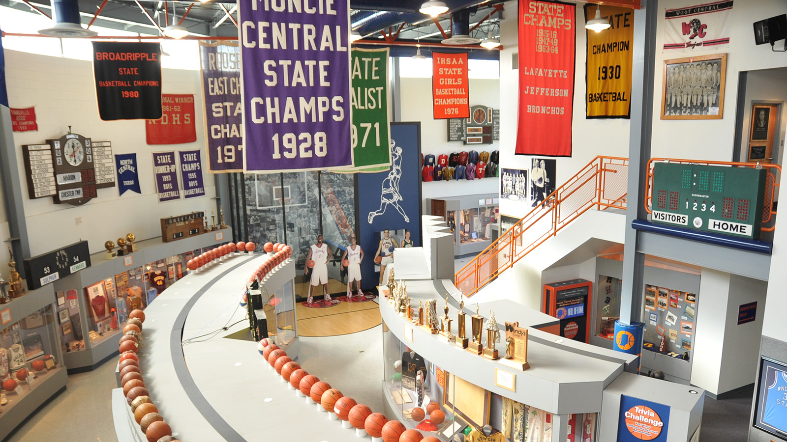 Memorabilia including jerseys, trophies, pendants, and plaques on display at the Indiana Basketball Hall of Fame